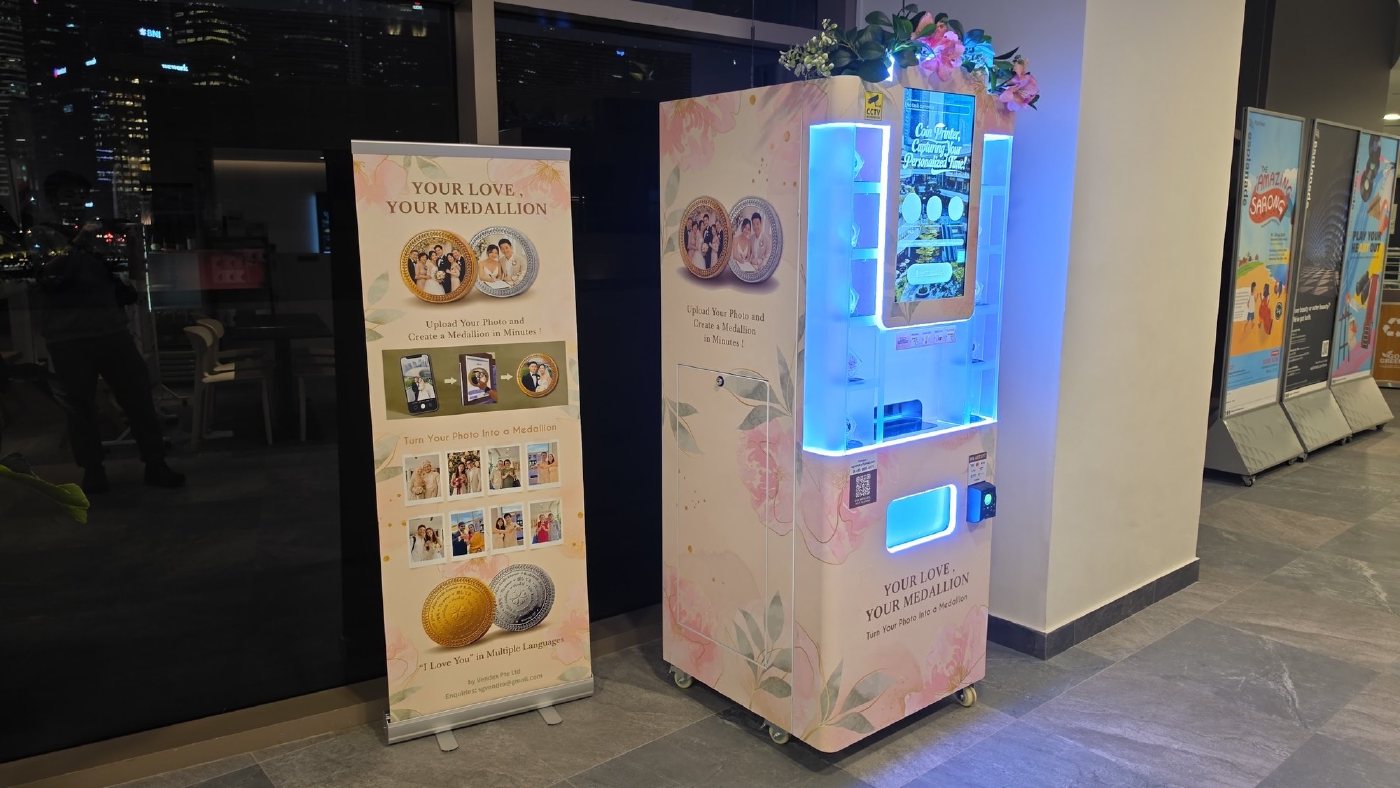 DIY Medallion machine and standing banner beside the windows at Esplanade Mall