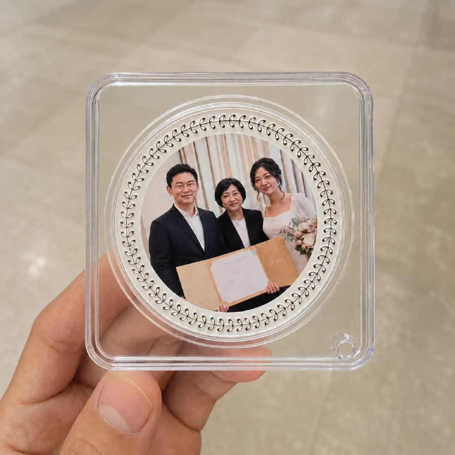 A finished personalised photo medallion held in a hand
